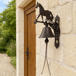 Large doorbell with a mare and foal on a stone façade