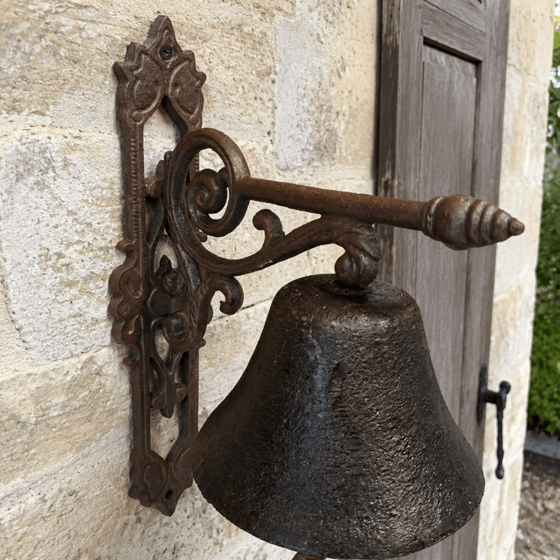 Detail of the scrollwork bracket of the rustic doorbell