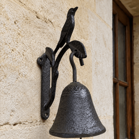 Detail of the bird wall bell with scrollwork bracket