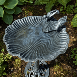 Shell-shaped cast iron bird bath with two decorative birds