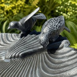 Decorative birds on large cast iron garden bird bath