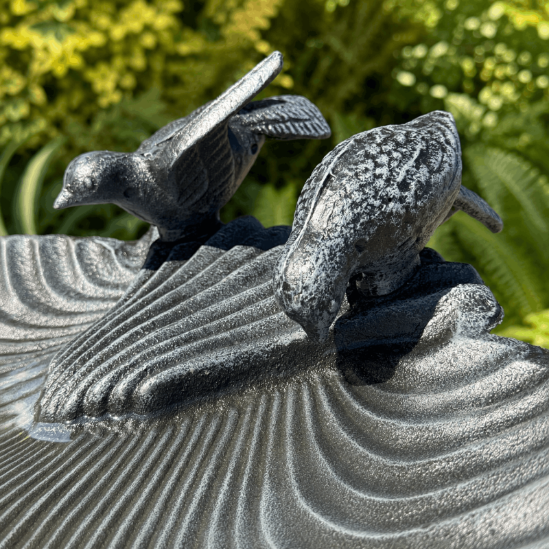 Decorative birds on large cast iron garden bird bath
