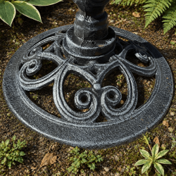 Ornate cast iron pedestal and openwork base of bird bath