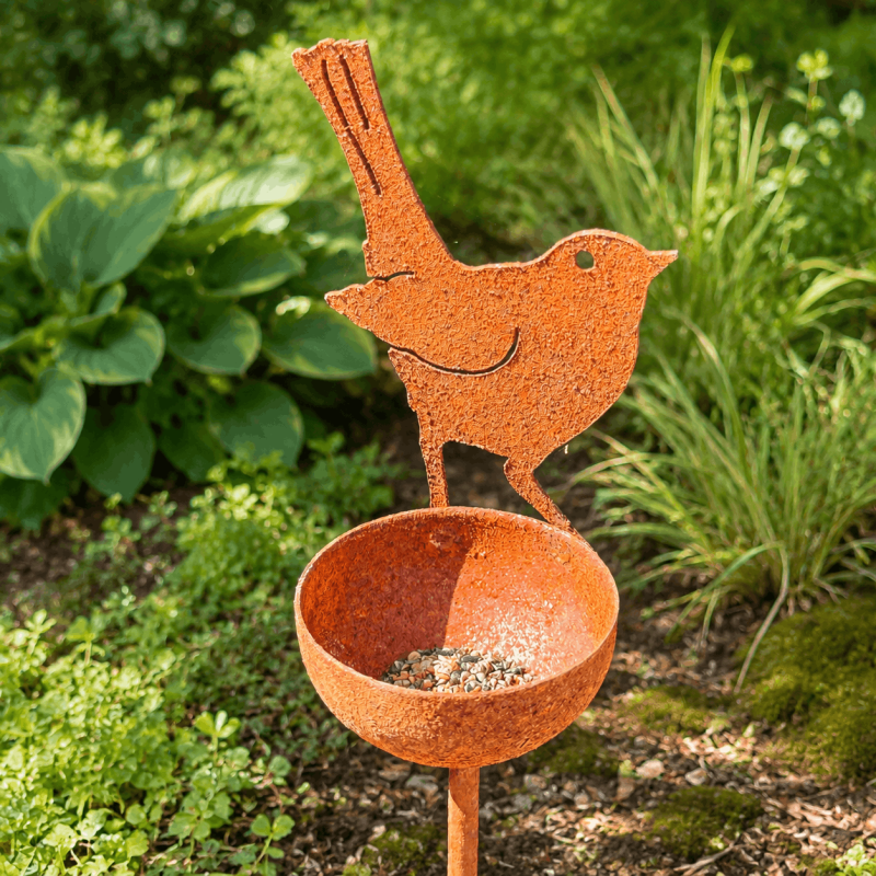 Decorative bird feeder with metal bird and seed bowl