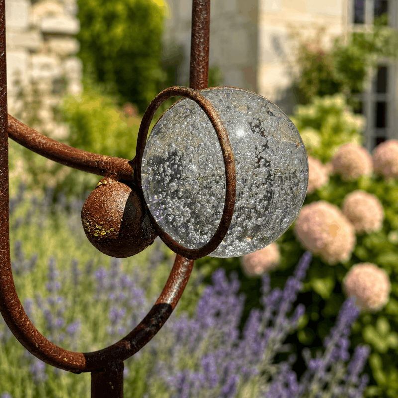 Bubbled glass counterweight on crow garden mobile