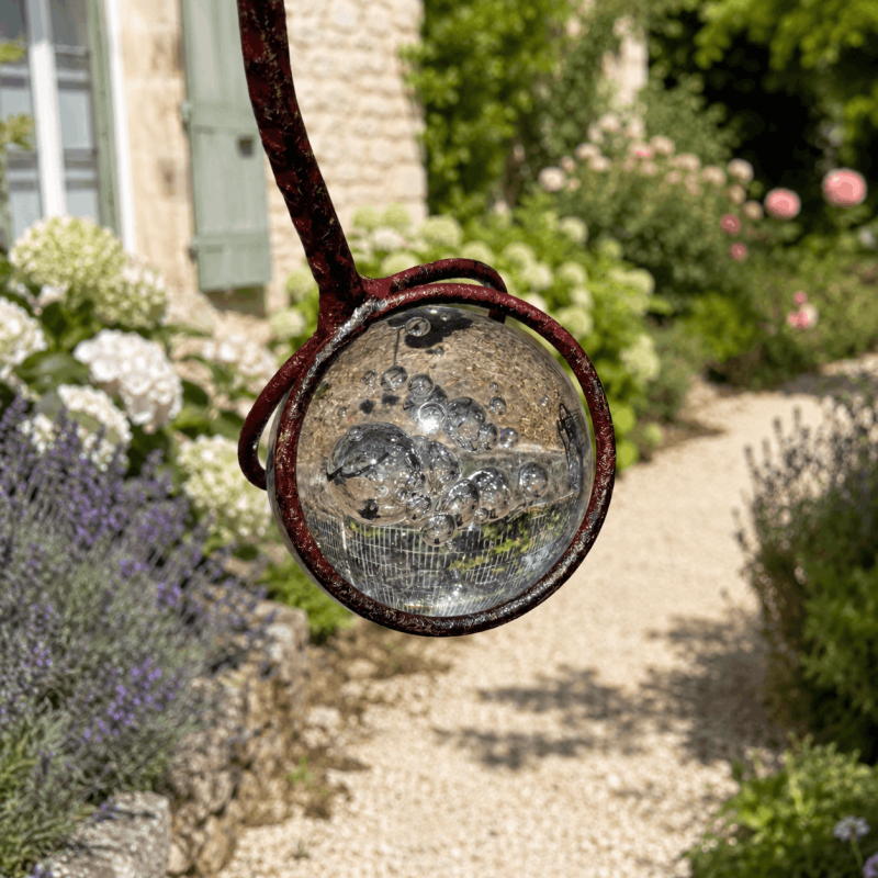 Bubbled glass counterweight on balancing garden mobile