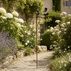 Balancing crow garden decoration on metal stake