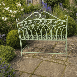 Floral pattern on the distressed sage-green metal garden bench