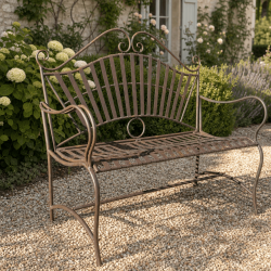 Wrought-iron garden bench with scrollwork and a fan-shaped backrest