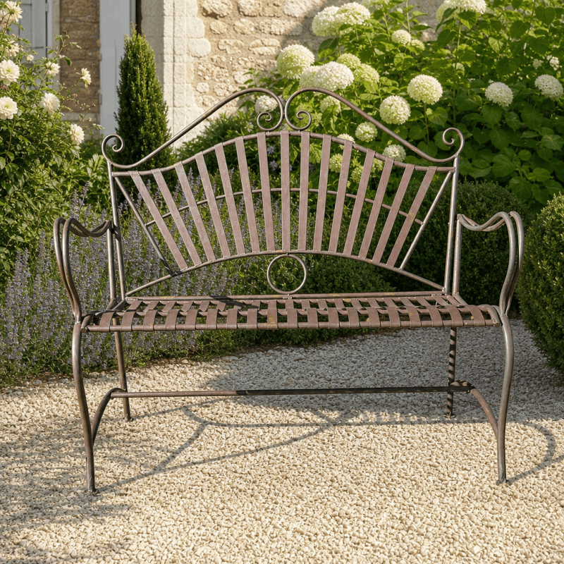 Patinated rust-brown wrought-iron garden bench with arabesque design