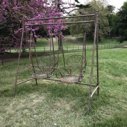 Comfortable Wrought Iron Garden Swing – Elegant Outdoor Setting