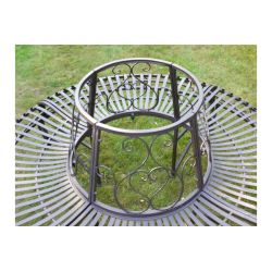 Top view of a patinated brown iron tree bench