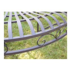 Patinated brown iron tree bench, side view