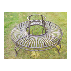 Top view of a patinated brown iron tree bench.