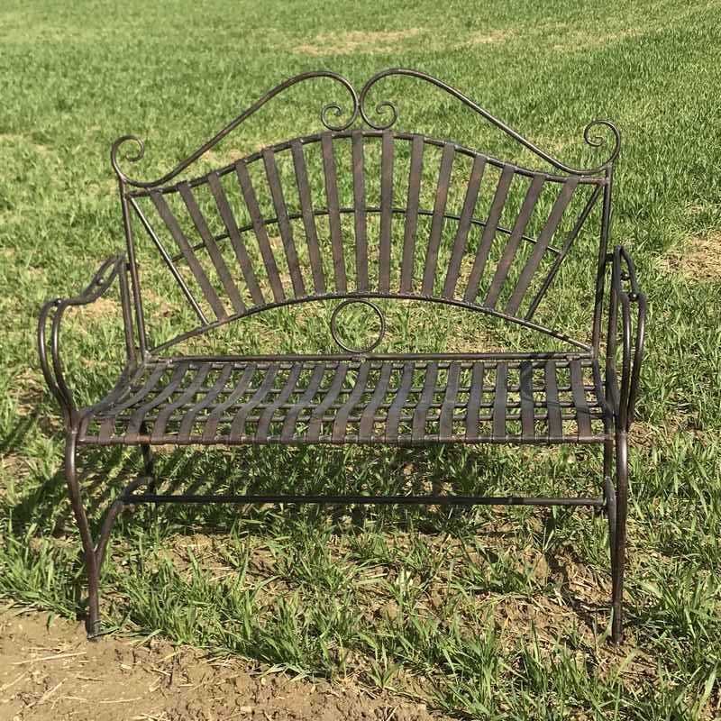 Arabesque wrought-iron garden bench staged in a setting