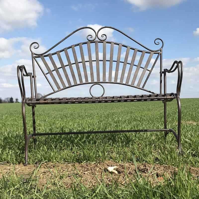 Wrought-iron garden bench with arabesque design, front view