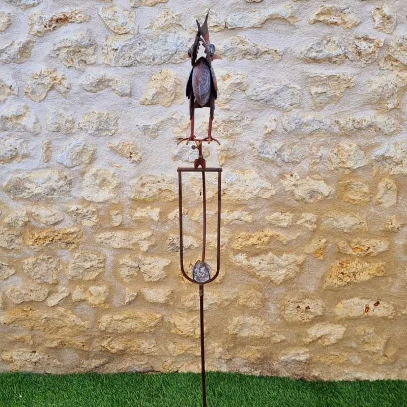 Decorative garden iron balance with colorful owl motif, side view