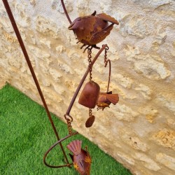 Decorative garden stake, cast iron bird bell, and garden wind spinner detail view