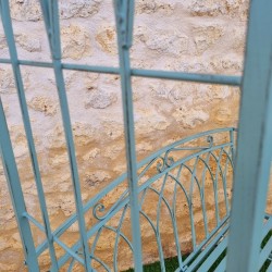 Comfortable antique green patinated wrought-iron garden arch bench