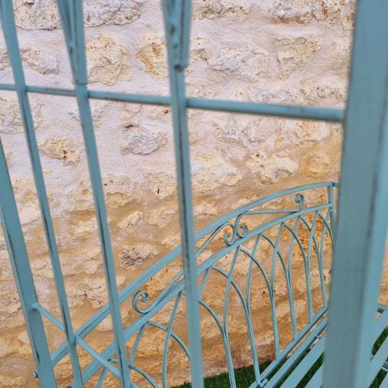 Comfortable antique green patinated wrought-iron garden arch bench