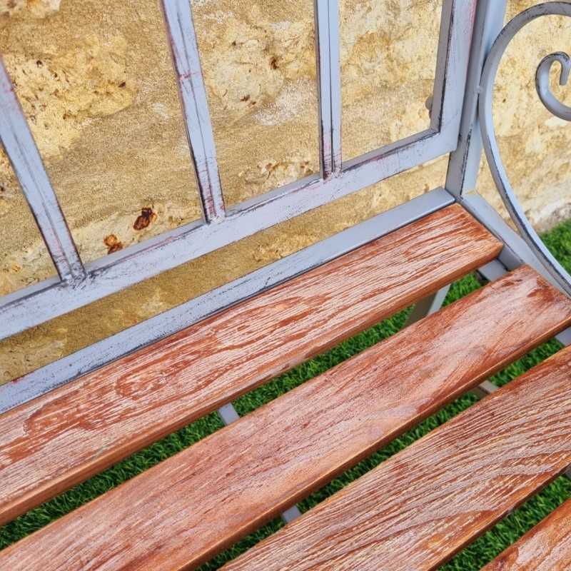 Comfortable antique gray weathered wrought-iron and wood garden bench