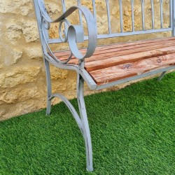 Comfortable antique gray weathered wrought-iron and wood garden bench