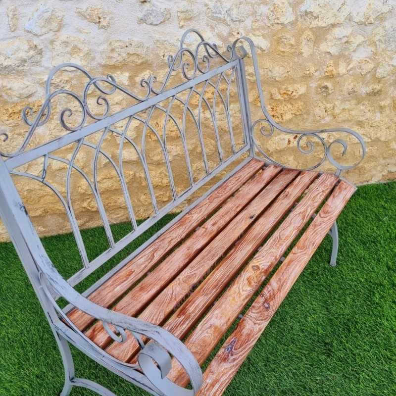 Comfortable antique gray weathered wrought-iron and wood garden bench