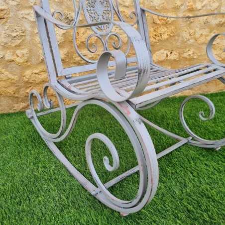 Rocking chair in iron and cast iron with an aged gray patina, outdoor, side view
