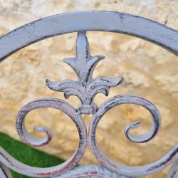 Rocking chair, iron and cast-iron armchair with an aged gray patina, for outdoor use, close-up view from above and patina
