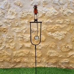 Counterbalance, metal stake, and glass bird with hat