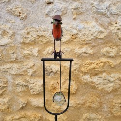 Counterbalance, metal stake, and glass bird with hat