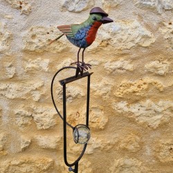 Counterbalance, metal stake, and glass bird with hat
