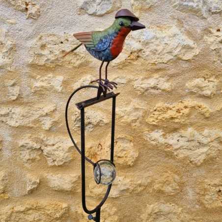 Counterbalance, metal stake, and glass bird with hat