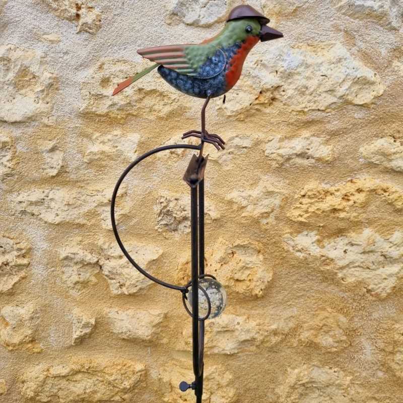 Counterbalance, metal stake, and glass bird with hat