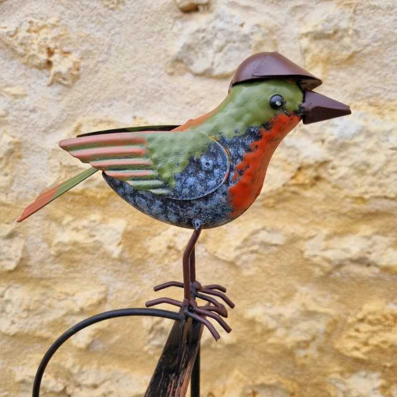 Counterbalance, metal stake, and glass bird with hat