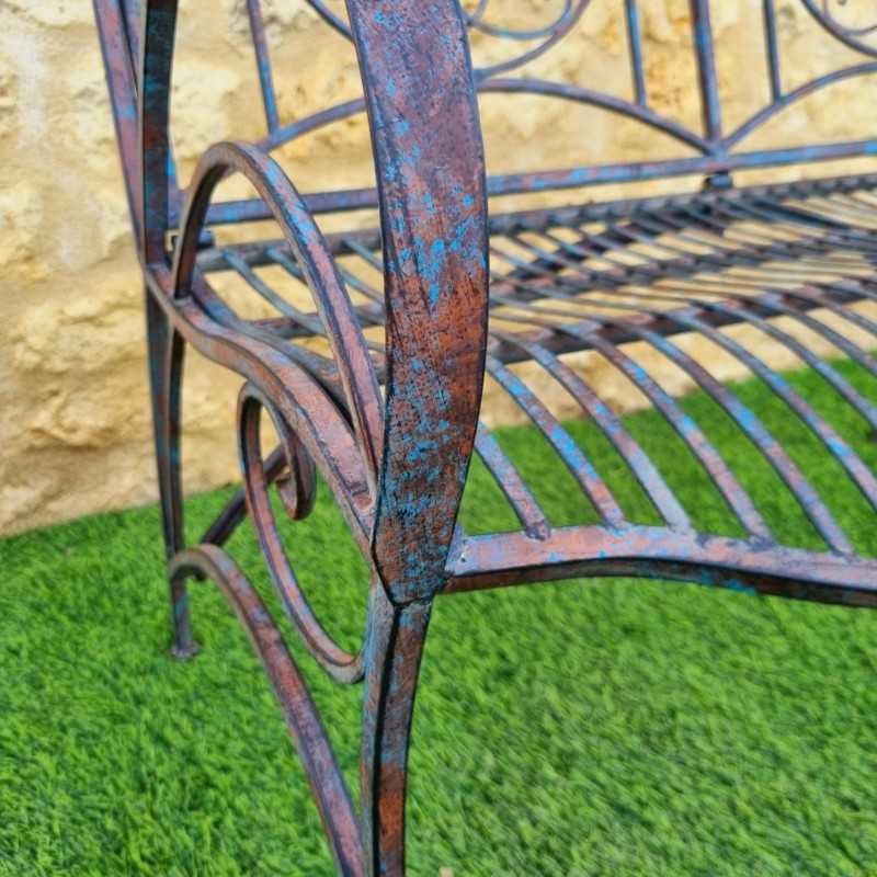 Antique rust-patina wrought-iron garden bench, comfortable, armrest view