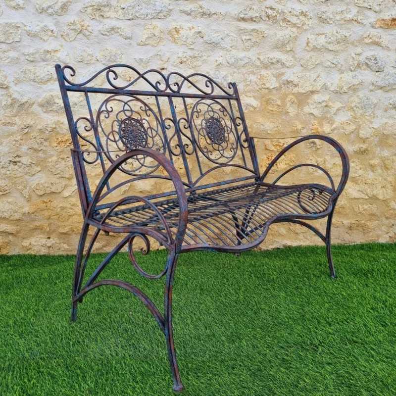 Wrought-iron garden bench with a patinated rust and antique blue finish
