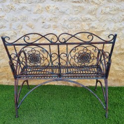 Antique rust-patinated wrought-iron garden bench, comfortable, rear view