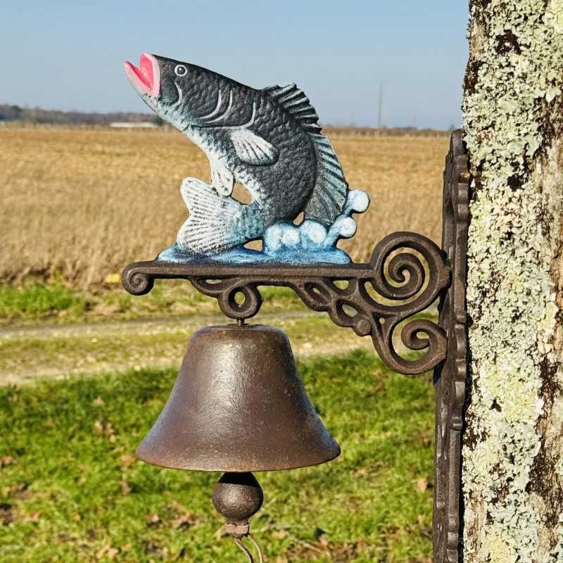 Cast iron wall bell mounted on a garden wall