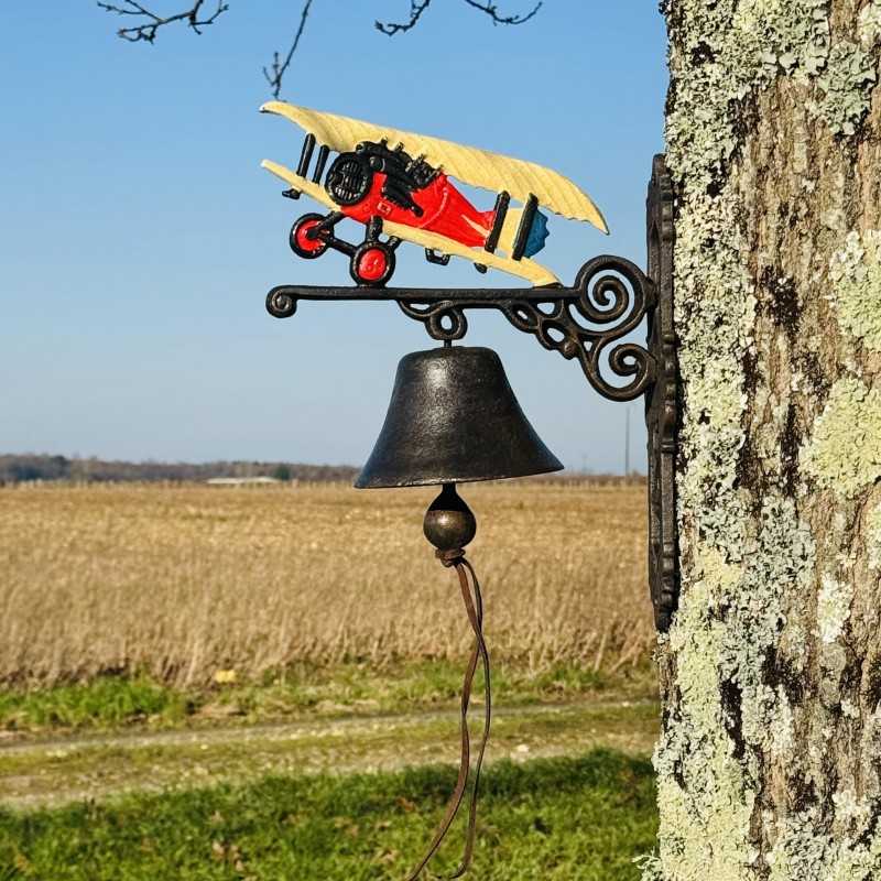 Close-up view of the cast iron bell featuring its vintage airplane design