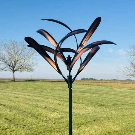 close-up view of a copper-colored decorative garden wind spinner