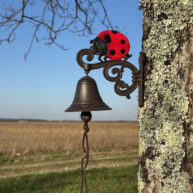 Detail of the red ladybug on the cast iron wall bell
