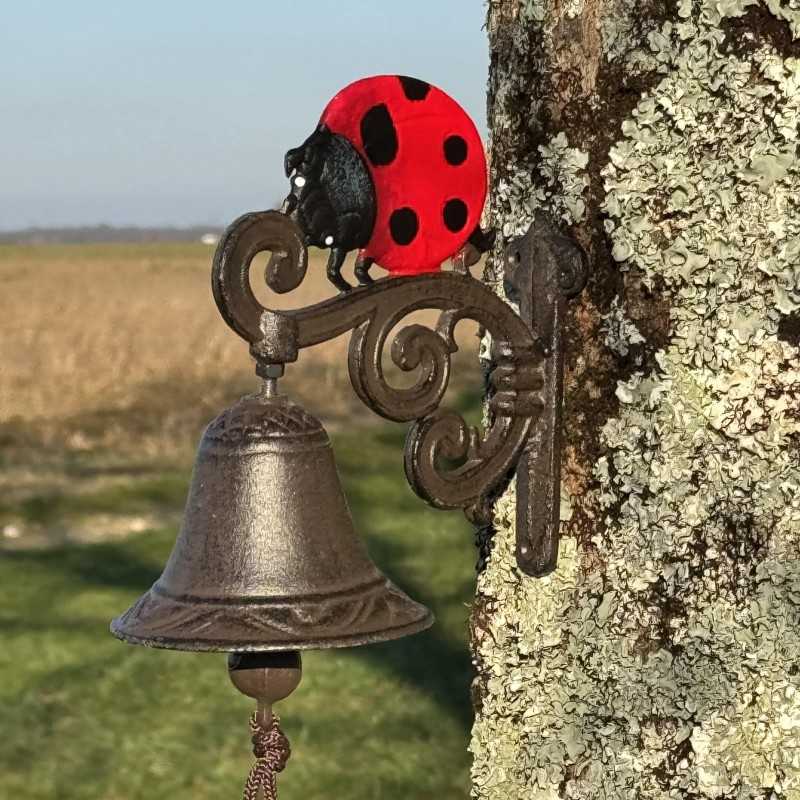 Cast iron wall bell with ladybug motif, side view
