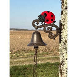 Close-up view of the decorative cast iron bell and red ladybug ornament