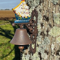Wall-mounted cast iron doorbell with a sailboat, front view