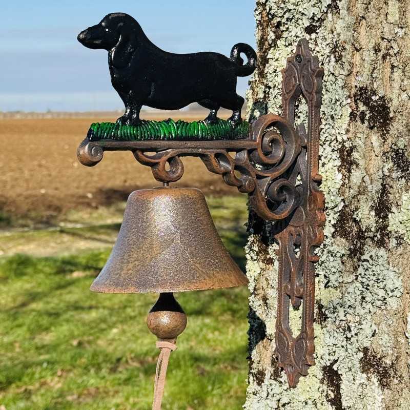 Wall-mounted cast-iron doorbell with dog, staged