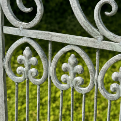 Detail of an antique design on a weathered metal garden bench