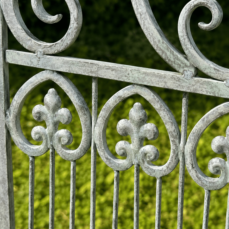 Detail of an antique design on a weathered metal garden bench