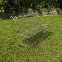 Patinated verdigris metal garden bench, side view