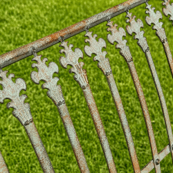 Patinated verdigris metal garden bench, close-up of the patina